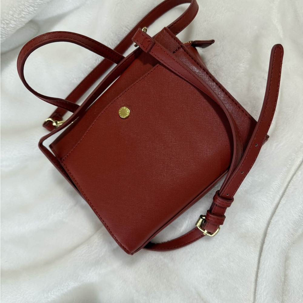 Sleek Red Crossbody Bag with Structured Shape and Gold Hardware